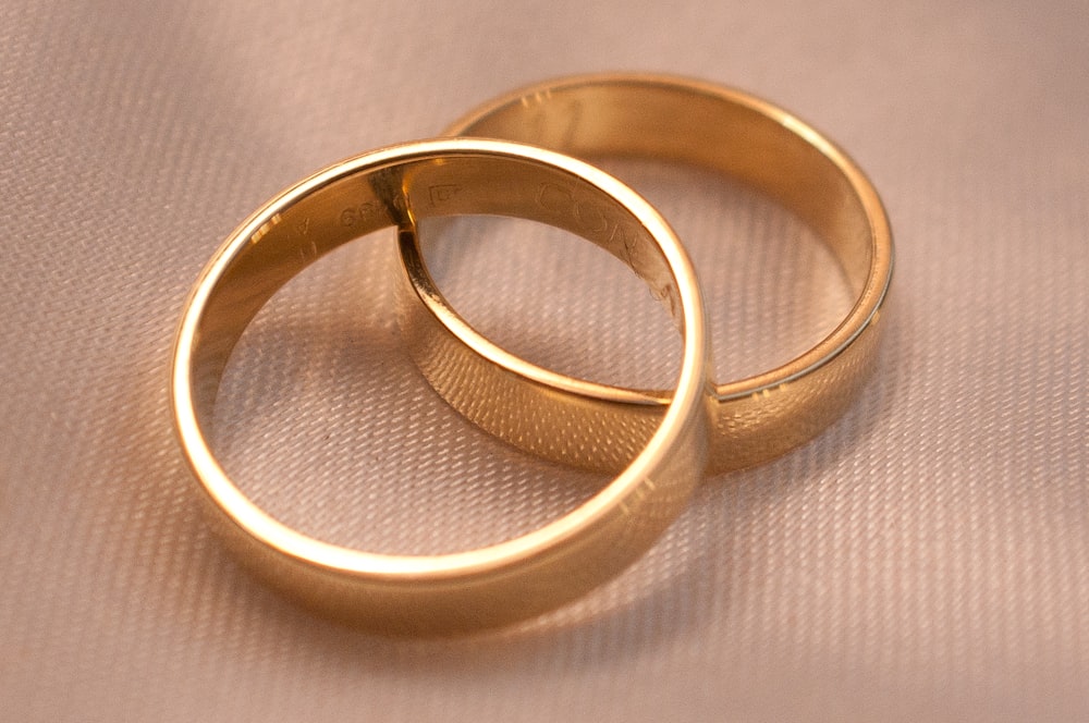 gold ring on white textile